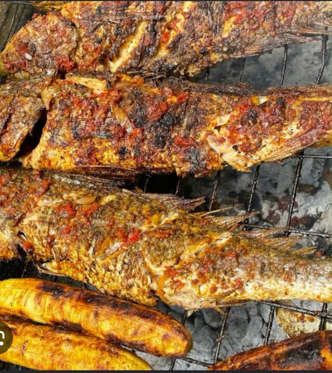 Charcoal flame-grilled seasoned fish with roast plantain